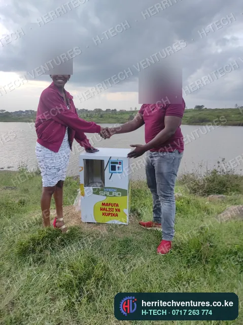 Handing over a cooking oil ATM to its new owner, May 2022