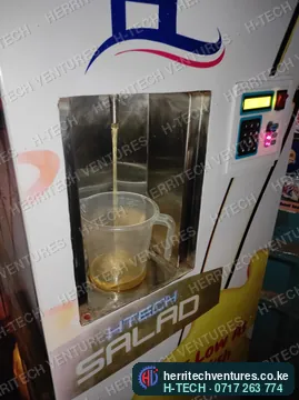 Dispensing cooking oil into a measuring jug to check the measure, May 2022
