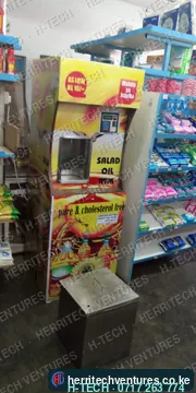 An H-TECH salad oil ATM in a supermarket, with its stainless drip box, January 2019