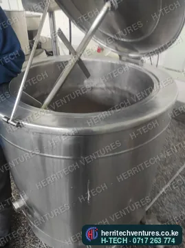 Inside a milk pasteurizer vat: stainless wall and stirrer, May 2023
