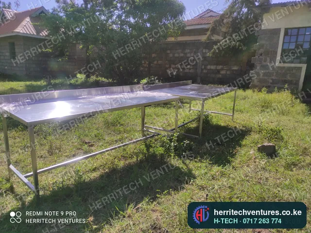 Long stainless steel work tables for a commercial kitchen, January 2022