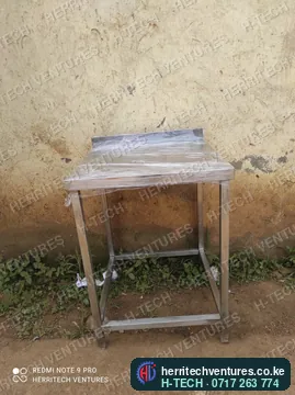 A compact stainless steel work table with a lower shelf frame, January 2022