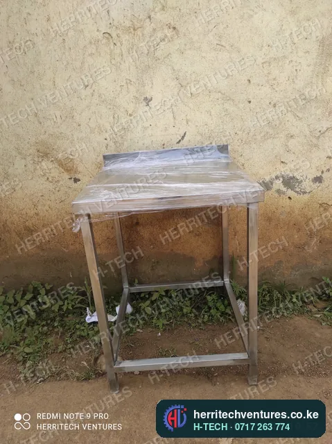 A compact stainless steel work table with a lower shelf frame, January 2022