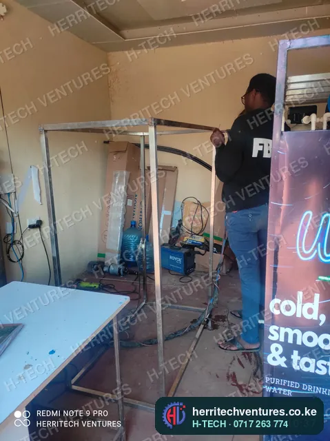 Welding the frame of a water refilling station enclosure in our workshop, January 2022